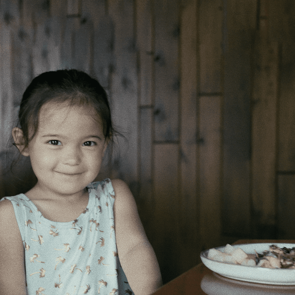 Ways to give page little girl eats at dinner table