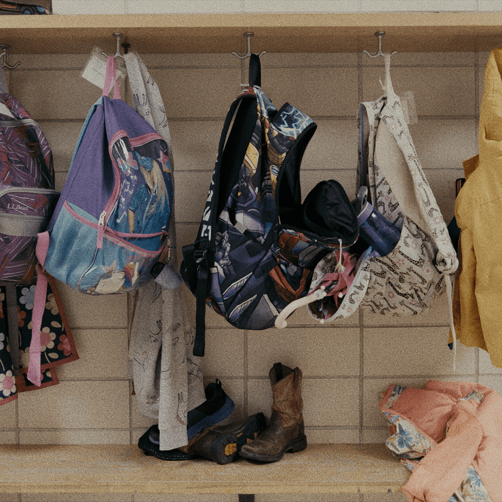 Summer Program - Every Meal school cubbies with back packs hanging