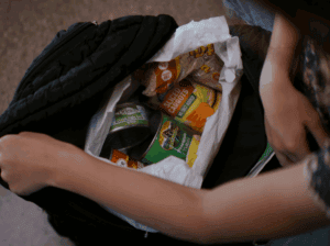 Brooklyn opening up backpack to find bag with food