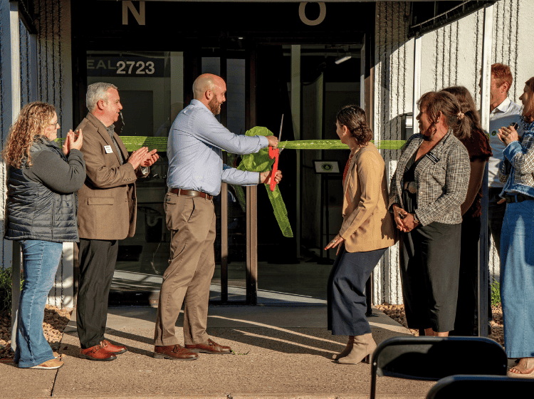 Cutting the ribbon on warehouse expansion and renovations for campaign celebration event on Oct 7